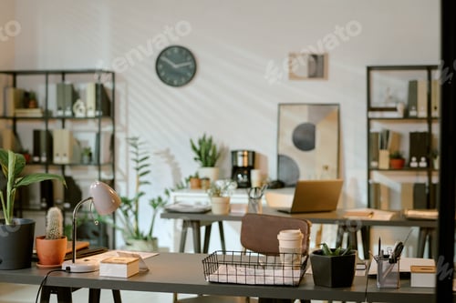 Preview: Modern Office Workspace Featuring Laptops and Indoor Plants in Daylight