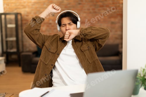 Preview: Sleepy Korean Student Guy Using Laptop Yawning Learning At Home