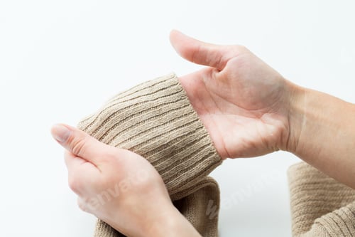 Preview: close up of hands with sweater sleeve