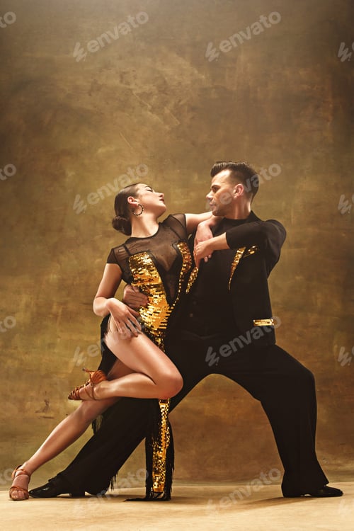 Preview: Dance ballroom couple in gold dress dancing on studio background.