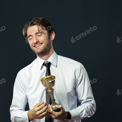 Preview: Businessman holding golden cup trophy