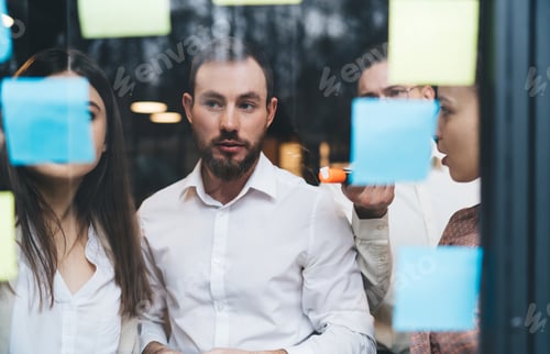 Preview: Puzzled coworkers working in creative company