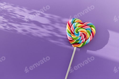Preview: Bright colorful heart shaped candy on purple background with shadows. Copy space. Minimalist concept