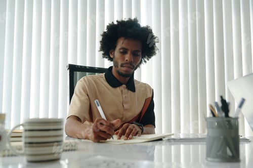 Preview: Businessman Making Notes At Meeting