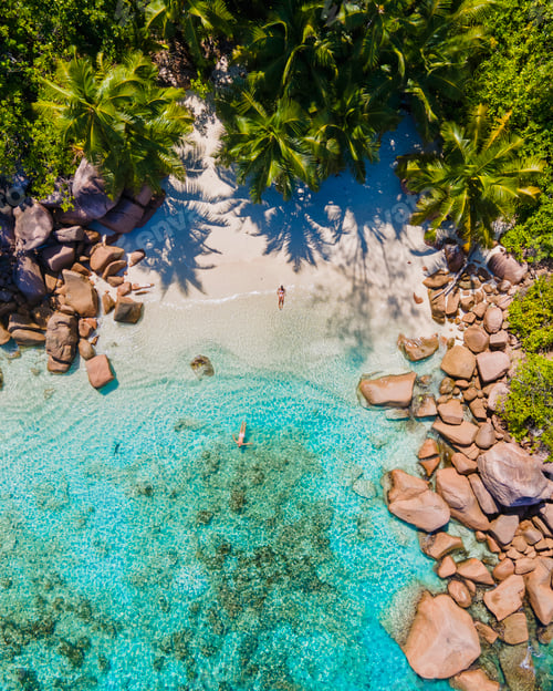 Preview: Praslin Seychelles tropical island with withe beaches and palm trees, couple men and women mid age