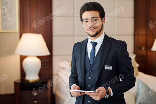 Preview: Young confident head manager of luxurious hotel looking at camera