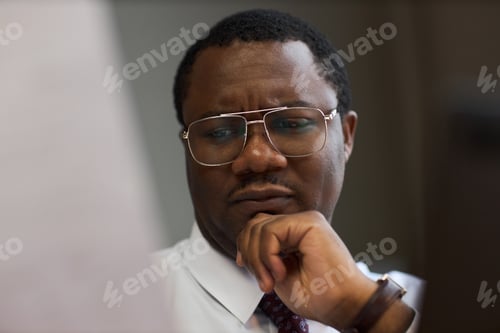 Preview: Middle Aged Black Man Reviewing Documents in Office as School Principal
