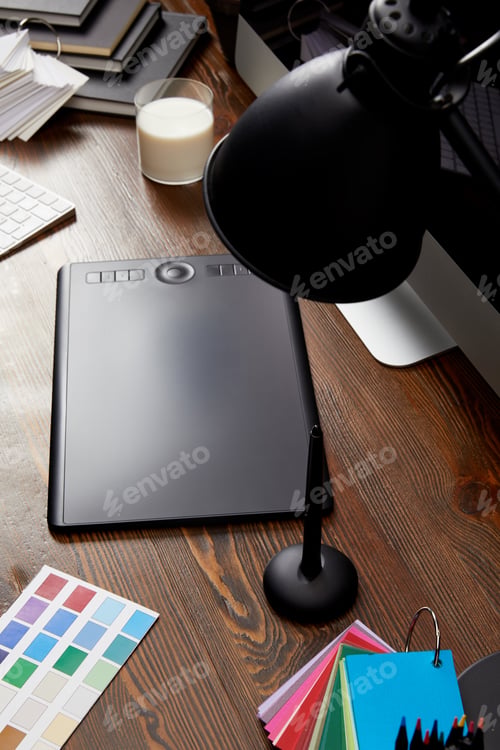 Preview: close up view of graphic designer workplace with colorful pallet, graphic tablet and computer screen