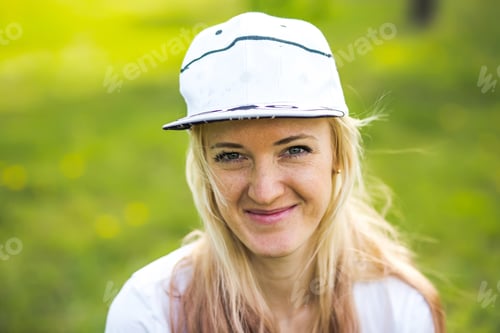 Preview: Portrait of a beautiful young woman in a baseball cap