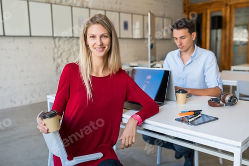 Preview: young man and woman working on laptop in open space co-working office room, busy freelancers
