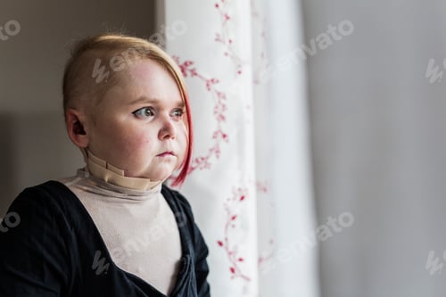 Preview: Portrait of disabled young woman looking through window