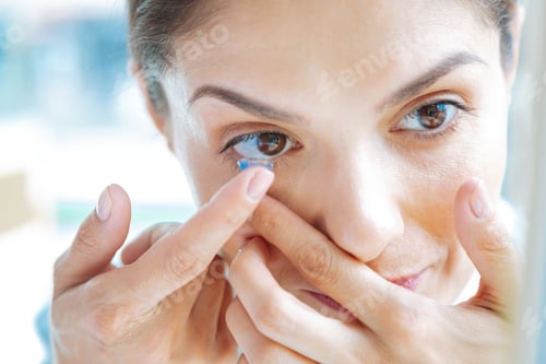 Preview: Close up of a female face with eye lenses