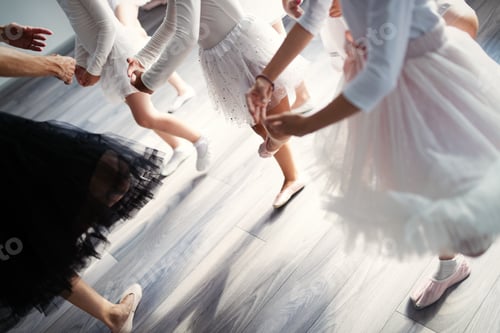 Preview: Ballet teacher and group of children ballerinas exercising in ballet studio