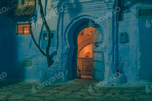 Preview: Ancient building with vintage doors at night