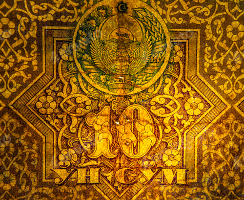 Preview: Closeup macro shot of a paper currency bill, with various elements of the design