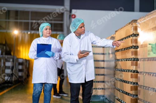 Preview: In warehouse quality control team checking drinking bottle stack on pallet before delivery