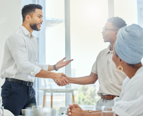 Preview: Cropped shot of two handsome young businessmen shaking hands during a meeting in the boardroom