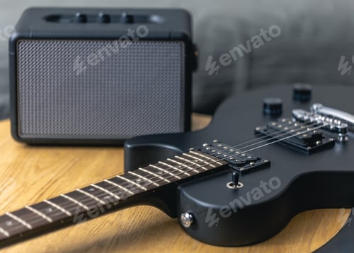 Preview: Black electric guitar and speaker close-up. Guitar amplifier, musical equipment.