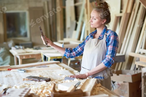 Preview: Female Carpenter Making Wooden Parts in Workshop