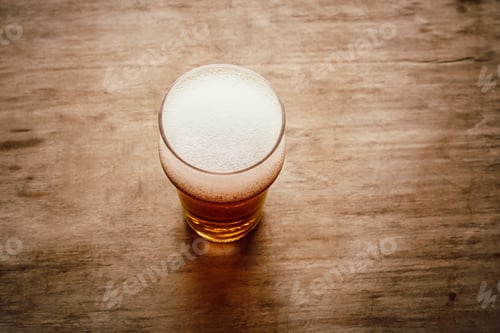 Preview: A glass with beer on the wooden background