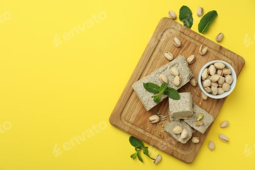 Preview: Concept of tasty food with halva on yellow background