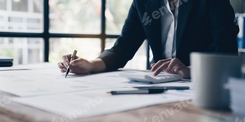 Preview: Consult financial concept. Business man pointing at papwework and using calculator