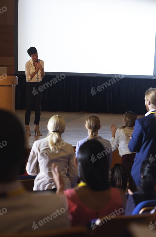 Preview: Beautiful businesswoman thanking the audience while finished her presentation in auditorium