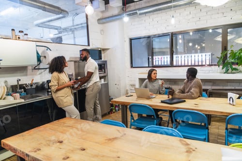 Preview: Young professionals enjoying coffee break in coworking space
