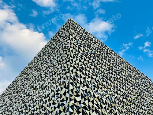 Preview: Low angle shot from ground. View of building corner against blue sky