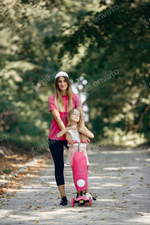 Preview: Mother with daughter playing in a summer park