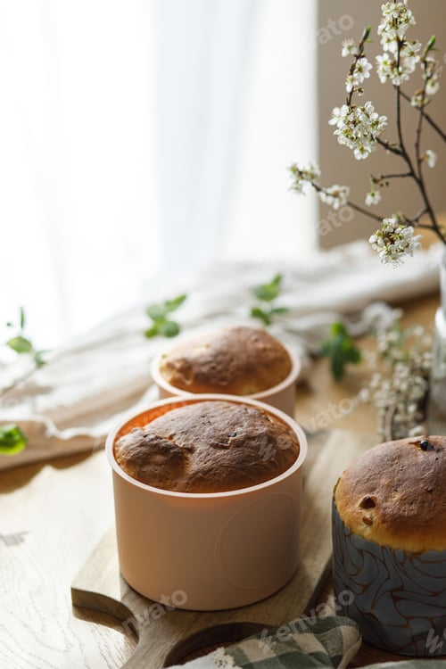 Preview: Baked fresh easter traditional bread on rustic wooden table with flowers