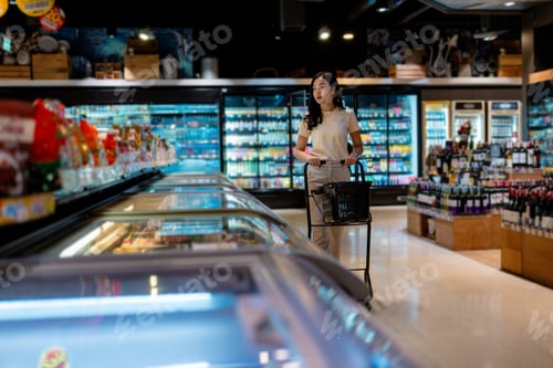 Preview: Young Woman Shopping in Modern Grocery Store