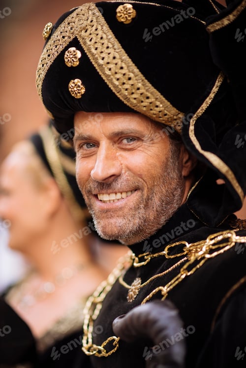 Preview: Portrait of man in black and gold costume at Palio di Asti medieval festival, Asti, Piedmont, Italy