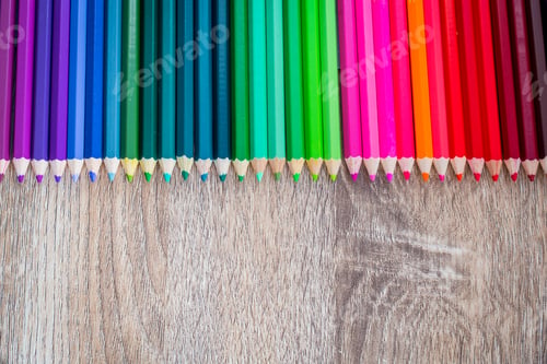 Preview: Multi Color pencils in scale with rainbow style isolated on wooden background