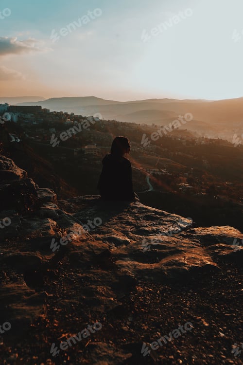 Preview: One woman sitting in sunset,