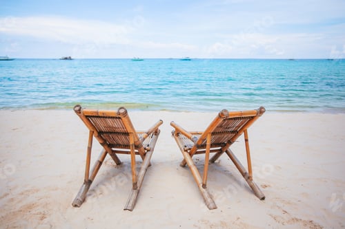 Preview: White lounge chairs on a beautiful tropical beach at Maldives