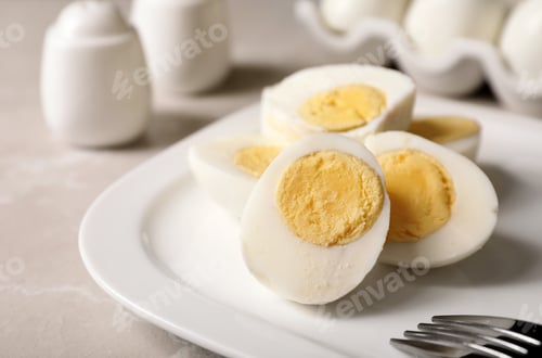 Preview: Plate with hard boiled eggs on table