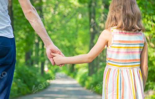 Preview: Father and child go holding hand. Selective focus.