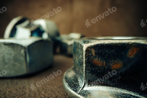 Preview: Macro shot of metal nuts on textured surface