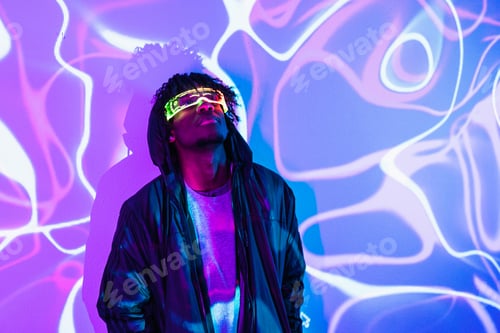 Preview: Afro futuristic man looking up using augmented reality goggles