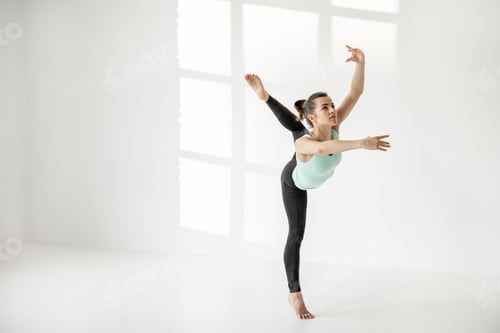 Preview: Woman practising rhythmic gymnastics alone