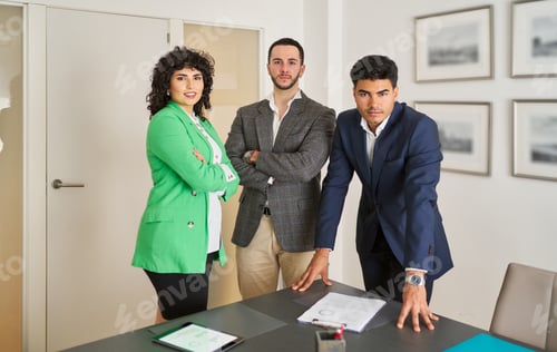 Preview: two men and a woman are standing in front of a table in the office with a white background.