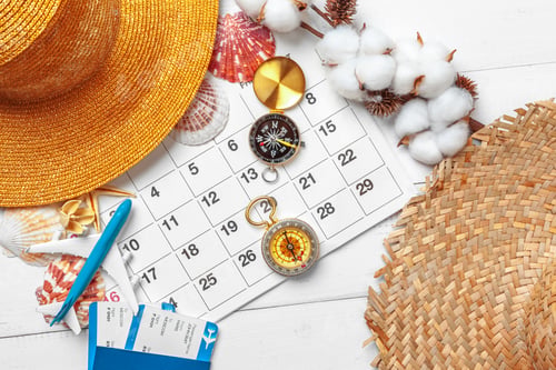 Preview: travel and vacation concept, compass on planner calendar