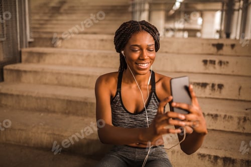 Preview: Smiling Woman Enjoying Music After a Workout