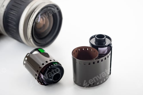 Preview: Single lens reflex camera and film rolls on a white background.