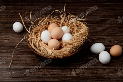 Preview: side view of basket of eggs in nest with eggs around on wooden background