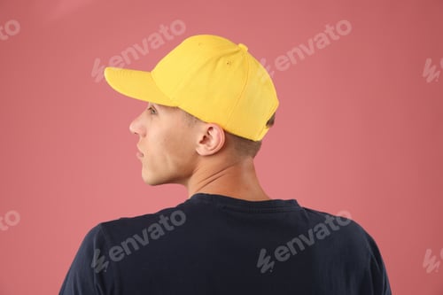 Preview: Young man in stylish baseball hat on pink background
