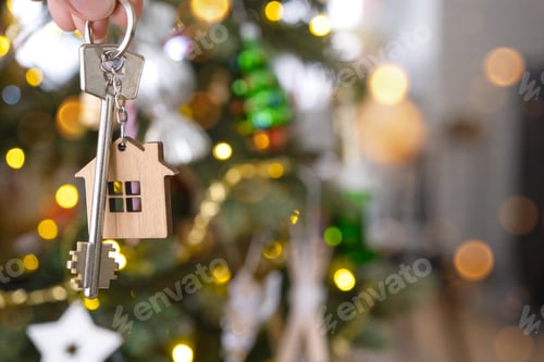 Preview: Key to the house with a keychain is hanging on the Christmas tree. A gift for New Year, Christmas. B