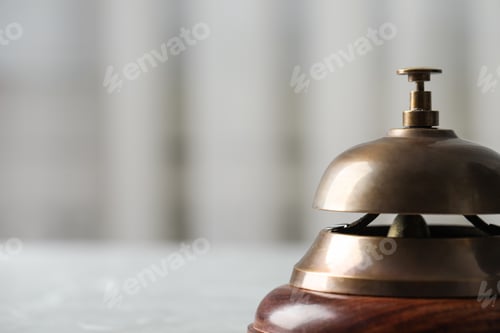 Preview: Hotel service bell on table, closeup. Space for text