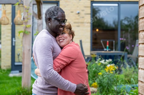 Preview: Mixed race parents embrassing in a tender loving hug. joy and passion